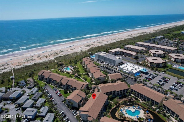 drone / aerial view with a beach view and a water view