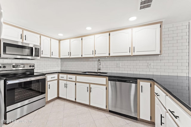 2280 Shepard St Unit 204, Jacksonville, FL 32211 - kitchen with stainless steel appliances, white cabinetry, sink, and decorative backsplash
