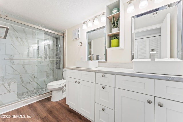 2280 Shepard St Unit 204, Jacksonville, FL 32211 - bathroom with vanity, hardwood / wood-style floors, a shower with door, and toilet