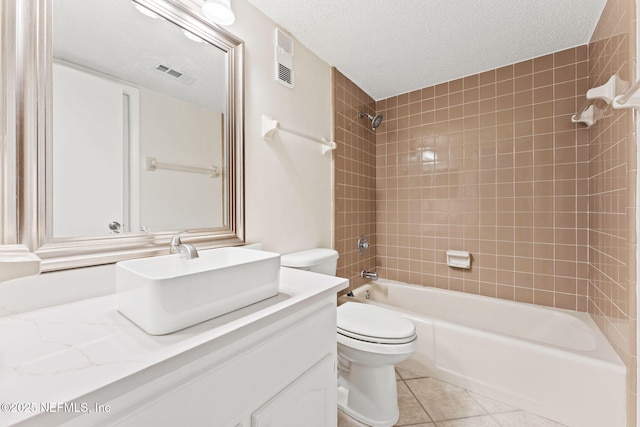 2280 Shepard St Unit 204, Jacksonville, FL 32211 - full bathroom featuring tile patterned flooring, vanity, tiled shower / bath combo, toilet, and a textured ceiling