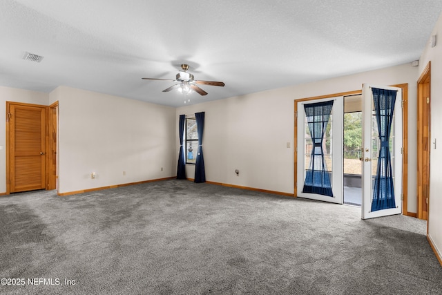 carpeted empty room with ceiling fan and a textured ceiling