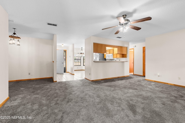 unfurnished living room with light carpet and ceiling fan