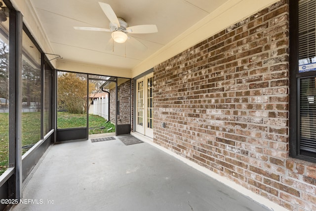 unfurnished sunroom featuring ceiling fan