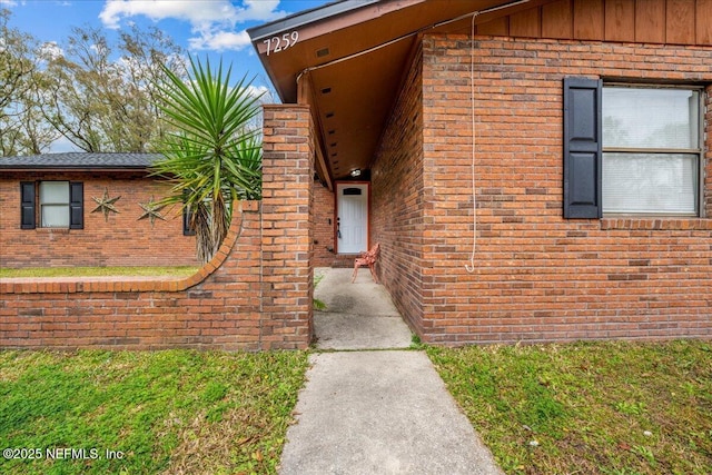 entrance to property with a yard