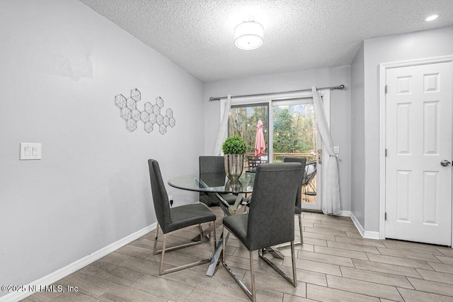 dining space with a textured ceiling