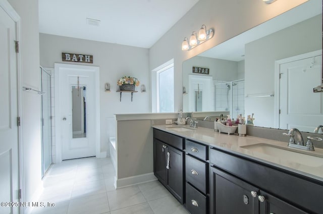 bathroom with a sink, a shower stall, a bath, and double vanity