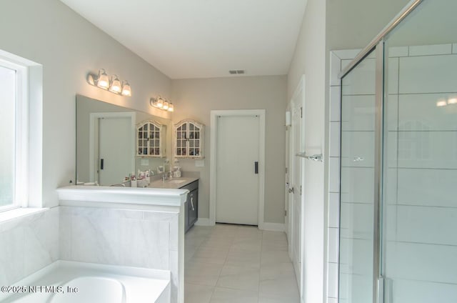 full bath featuring a garden tub, vanity, visible vents, tile patterned floors, and a stall shower