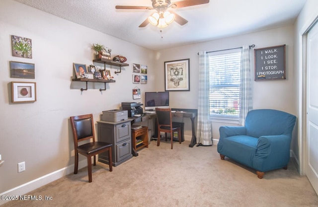 office area with ceiling fan, baseboards, and light colored carpet