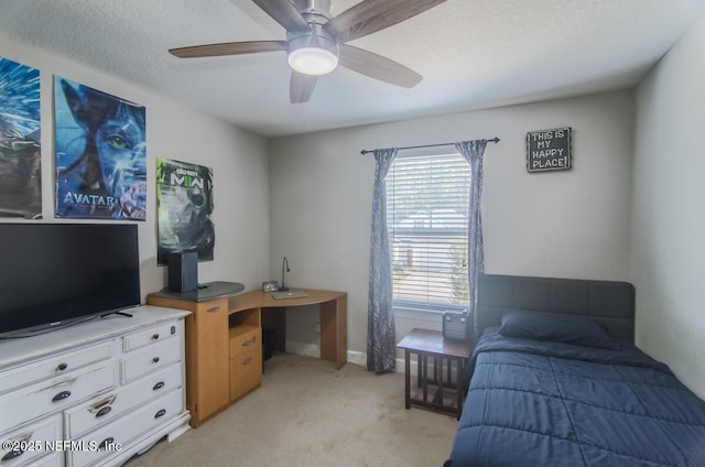 bedroom with a ceiling fan, a textured ceiling, and light colored carpet