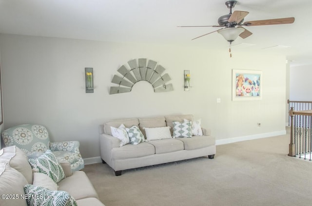 carpeted living room featuring a ceiling fan and baseboards