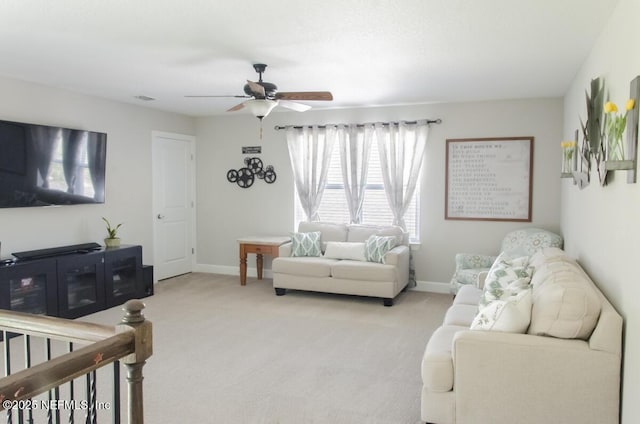 living room featuring carpet floors, visible vents, a ceiling fan, and baseboards