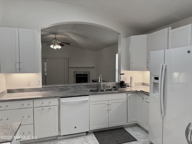 kitchen with white cabinetry, white appliances, and sink