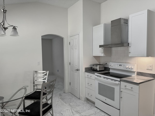 kitchen featuring white cabinets, white range with electric cooktop, pendant lighting, and wall chimney range hood