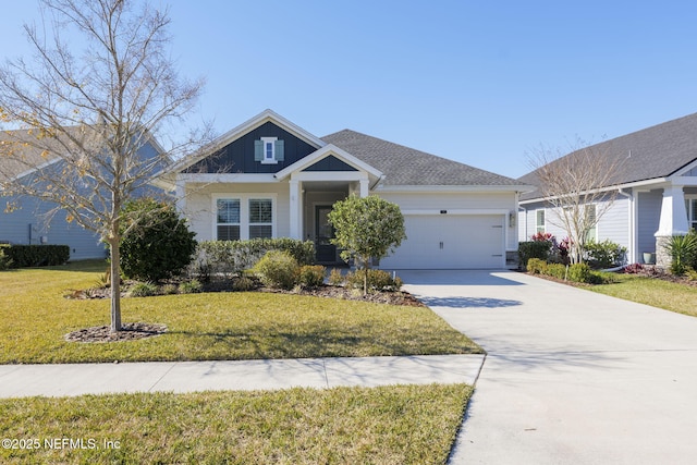 view of front of home featuring a garage and a front yard