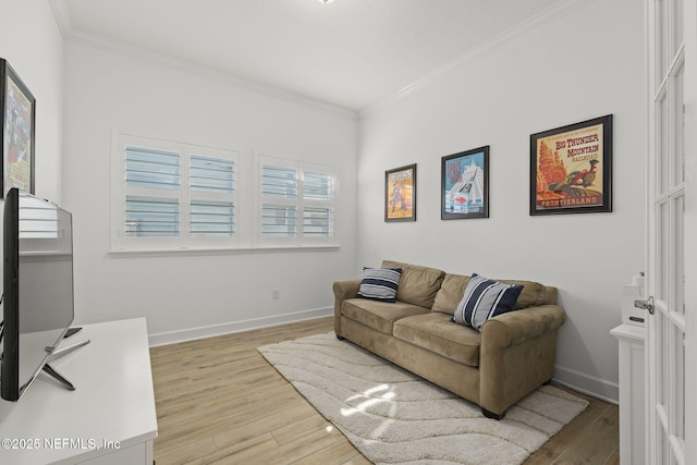 living room featuring crown molding and light hardwood / wood-style floors