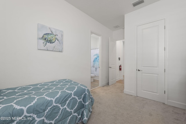 carpeted bedroom with ensuite bathroom