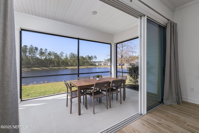 sunroom / solarium with a water view