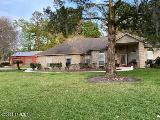 single story home featuring a garage and a front lawn