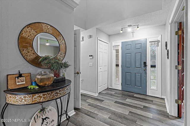 foyer entrance featuring hardwood / wood-style floors and a textured ceiling