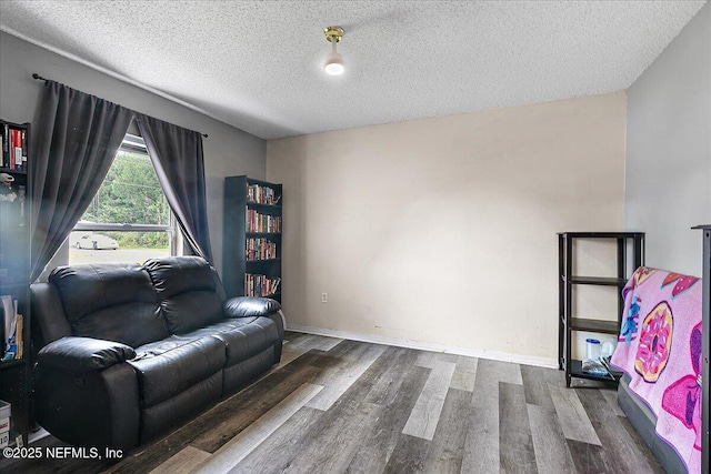 living room with dark hardwood / wood-style flooring and a textured ceiling