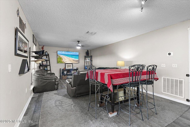 interior space featuring ceiling fan and a textured ceiling