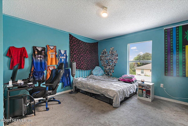 bedroom with carpet floors and a textured ceiling