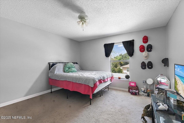 bedroom featuring ceiling fan, carpet flooring, and a textured ceiling