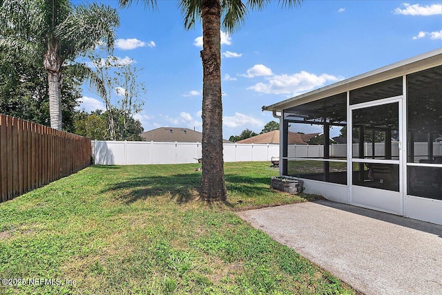 view of yard featuring a patio and a sunroom