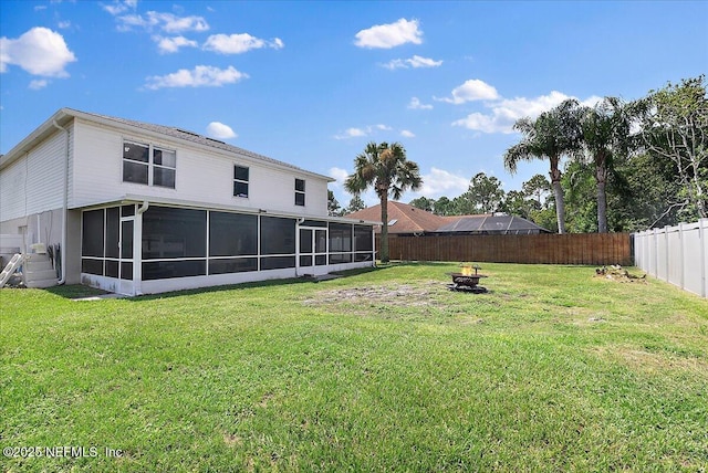 view of yard featuring an outdoor fire pit and a sunroom