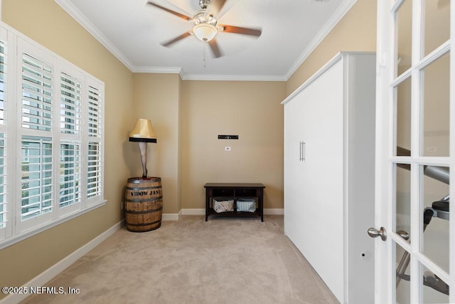 interior space with crown molding, light colored carpet, french doors, and ceiling fan