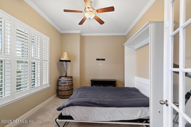 carpeted bedroom with ornamental molding and ceiling fan