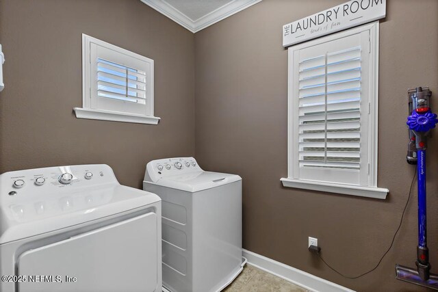 clothes washing area with ornamental molding and washing machine and dryer