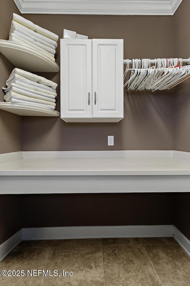 laundry area featuring ornamental molding