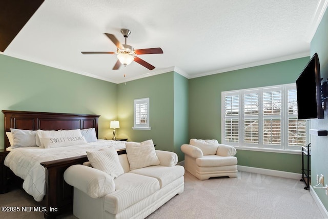 carpeted bedroom featuring ornamental molding and ceiling fan