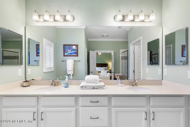 bathroom with an enclosed shower, crown molding, and vanity