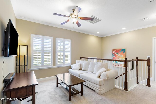 carpeted living room featuring ornamental molding and ceiling fan