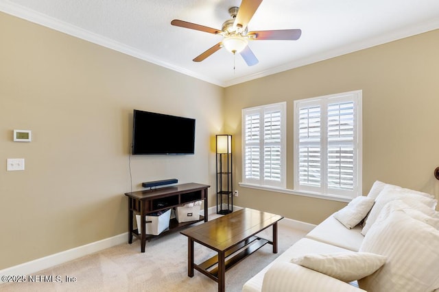 carpeted living room with crown molding and ceiling fan