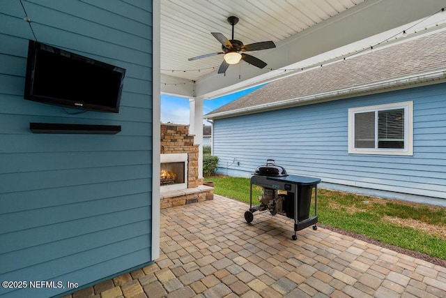 view of patio / terrace featuring an outdoor stone fireplace