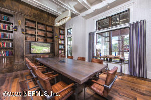 office with hardwood / wood-style flooring, a healthy amount of sunlight, and built in shelves