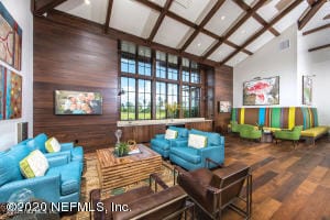 living room featuring beam ceiling, high vaulted ceiling, hardwood / wood-style floors, and wooden walls