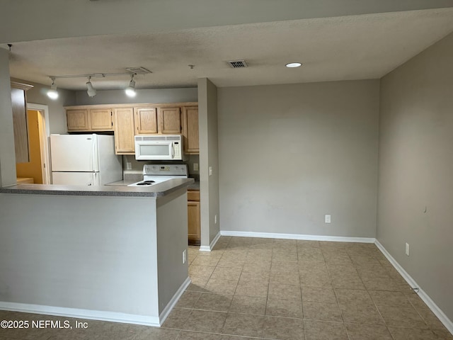 kitchen featuring light brown cabinets, a textured ceiling, and white appliances