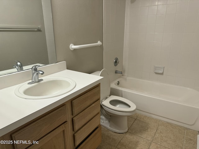 full bathroom with tile patterned flooring, vanity, tiled shower / bath, and toilet