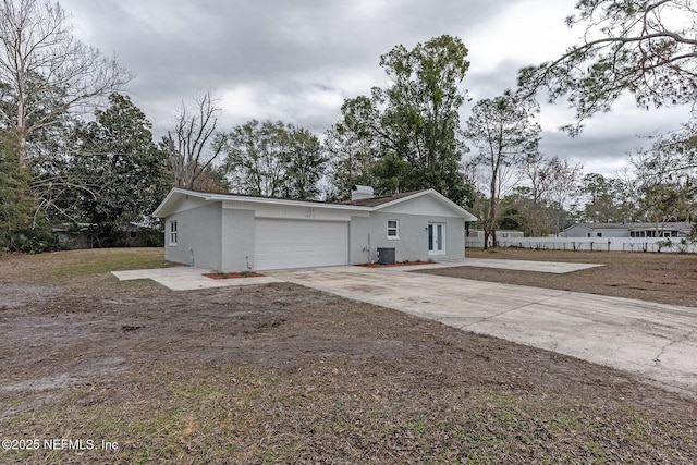 view of front of house featuring a garage and central AC unit