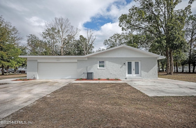 single story home featuring central AC unit and french doors