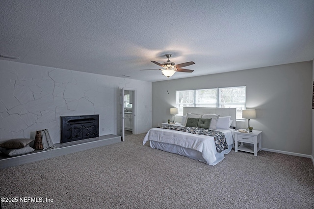 carpeted bedroom featuring ceiling fan, a fireplace, and a textured ceiling