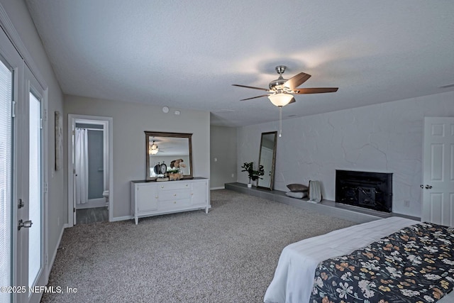 carpeted bedroom with ceiling fan and a textured ceiling