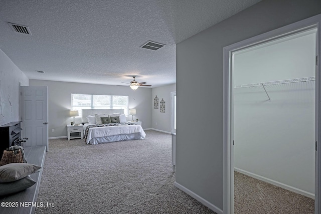 unfurnished bedroom with ceiling fan, carpet, and a textured ceiling