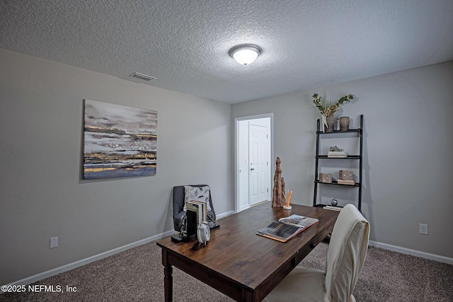 carpeted office space featuring a textured ceiling