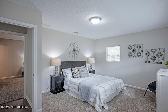 carpeted bedroom featuring a textured ceiling