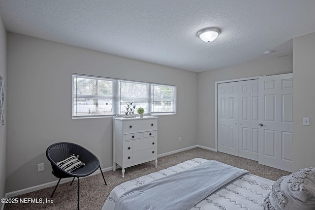 carpeted bedroom with a textured ceiling and a closet